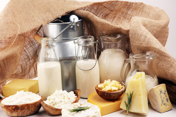 Different  healthy dairy products on rustic background with milk, cheese, butter and cottage