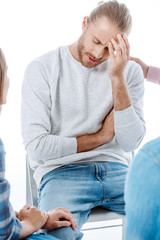 support group helping sad man on chair isolated on white