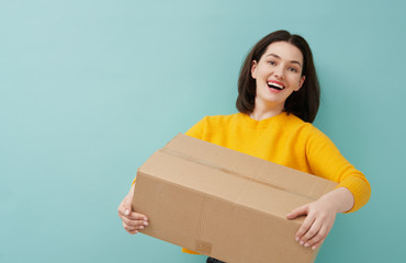woman is holding cardboard box