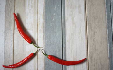 Top view of red hot chili peppers over vintage background.
