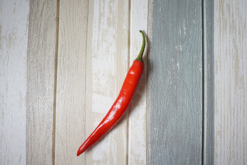 Top view of red hot chili pepper over vintage background.