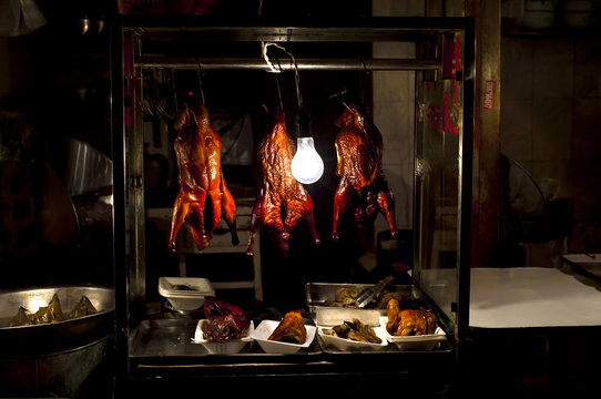 Roast chickens hanging at a Chinese wet market in Shanghai's old town