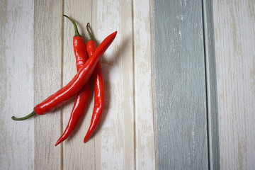 Top view of red hot chili pepper over vintage background.