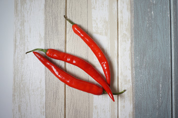 Top view of red hot chili pepper over vintage background.