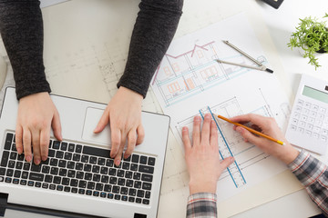 Architects working on blueprint, real estate project. Architect workplace - architectural project, blueprints, ruler, calculator, laptop and divider compass. Construction concept. Engineering tools.