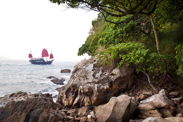 Traditional Chinese junk sailing off Hong Kong Island
