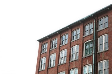 Old abandoned brick factory clock tower industrial vacant building with clock 