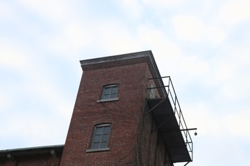Old abandoned brick factory clock tower industrial vacant building with clock 