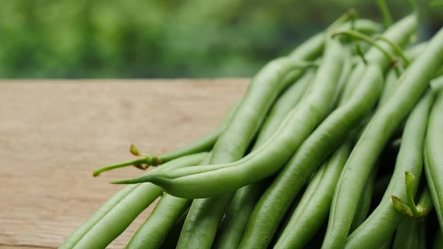 Green beans on wooden board with copy space