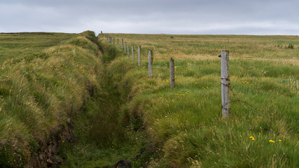 Fototapeta na wymiar Fence in a field, Downpatrick Head, Killala, County Mayo, Ireland