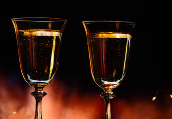 Two glasses with champagne sparkling wine  on a dark background  Atmosphere of celebration, magic and happiness.