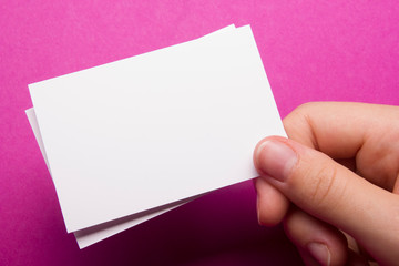 Hand holding business card blank on abstract background