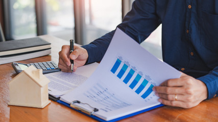 buy or sell real estate concept, Sale representative offer house purchase contract to buy a house or apartment and give home key chain to customer.