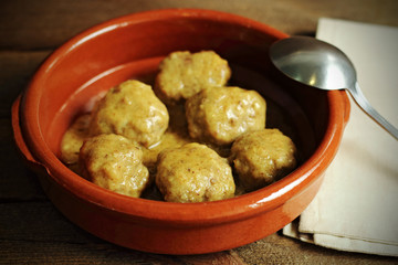 Meatballs in clay casserole and napkin
