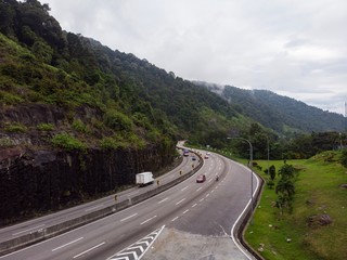 Scenic aerial view of &ldquo;Lebuhraya Utara-Selatan&rdquo;, a highway located in Malaysia. Highway surrounded by forest, winding road