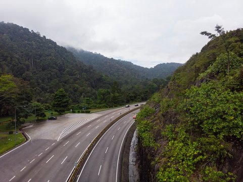 Scenic aerial view of &ldquo;Lebuhraya Utara-Selatan&rdquo;, a highway located in Malaysia. Highway surrounded by forest, winding road