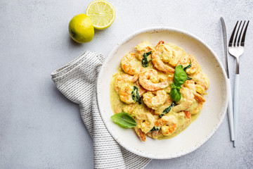 Shrimps in cream sauce with Coconut milk on a plate, top view or view from above, flat lay
