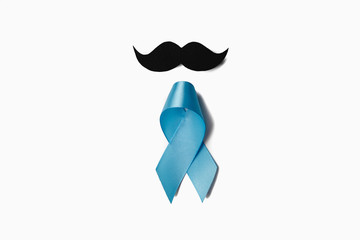 Symbol for support men. Top view on blue Ribbon with mustache for supporting people living and illness. Healthcare, International men, Father and World cancer day concept. Flat lay, copy space