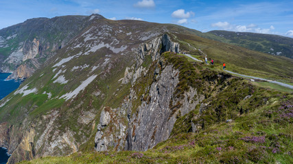 Naklejka premium Tourists walking on hill, Slieve League, County Donegal, Ireland