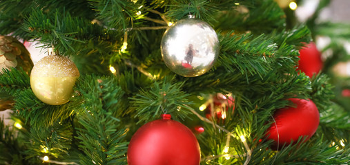 Blurry of Christmas and New Year's balls with beautiful decorations on the Christmas tree, soft light, beautiful background images and illustrations.