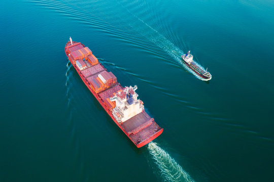Aerial view container cargo ship and oil tanker ship on the sea for business logistics, import export, shipping or transportation.