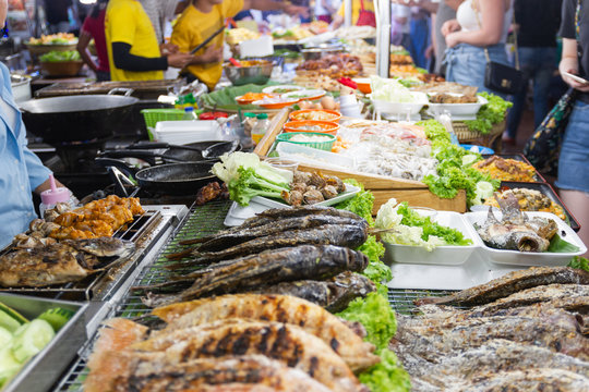 street foods of Thailand, foods style Grilled seafood feast for the party at night market Bangkok of Thailand