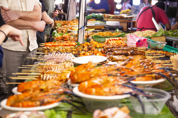 street foods of Thailand, foods styleGrilled seafood feast for the party at night market Bangkok of Thailand - obrazy, fototapety, plakaty