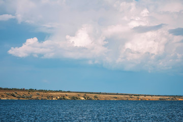 cliff shore with sea and clouds in the sky