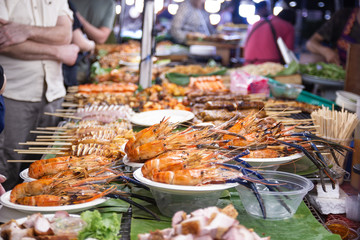 street foods of Thailand, foods style Grilled seafood feast for the party at night market Bangkok of Thailand