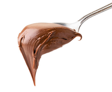 Chocolate cream in metal spoon close up on a white. Isolated