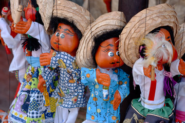 DOLLS MADE BY HAND IN MEXICO. Photograph of some mexican traditional dolls. Mexican marionettes puppets. Marionettes in Riviera Maya Mexico