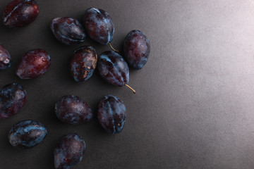 Fresh mouth watering plums, summer concept, copy space.
