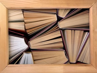 Fototapeta premium Background texture: ajar pages of books. Old hardback textbooks, on black background. Concept: education, self-improvement, personal growth.