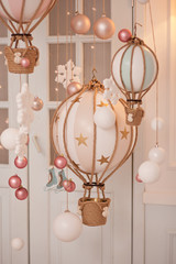 Room decorated balls and toy miniature aerostats for Christmas in a beige color