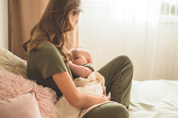 The concept of breastfeeding. Portrait of mom and breastfeeding baby. 