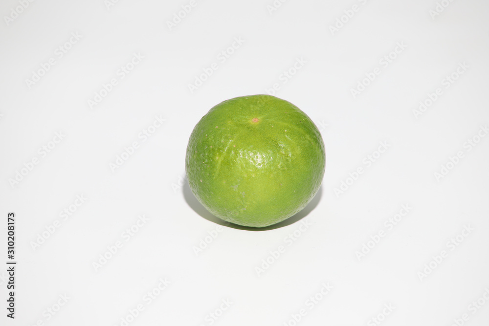 Wall mural fresh green lime isolated on white background