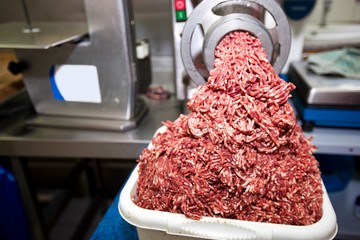 Machine mincing meat in grocery store