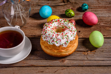 Easter cake and colorful eggs on a dark background