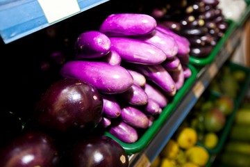 Variety of eggplants on display in grocery store