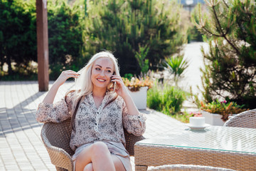 girl at the beach restaurant talking on the phone