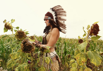 An Indian girl is seen in a dried out crop field. Her unhappy face reveals that the land is dried ...