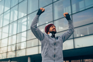 happy jogger holding hands up , winner , outdoors