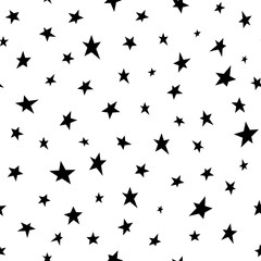 Seamless abstract pattern with black hand drawn shabby stars of different size on white background.