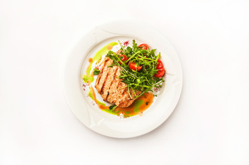 Chicken fillet in a restaurant close-up. Wild duck fillet with vegetables on a white plate and copy space.