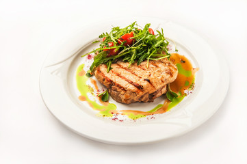 Chicken fillet in a restaurant close-up. Wild duck fillet with vegetables on a white plate and copy space.