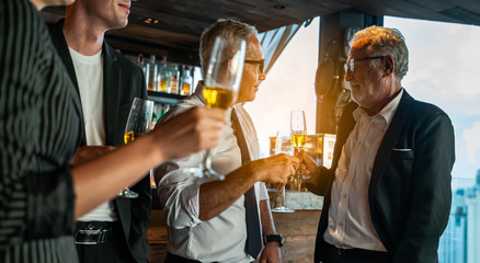 Toasting to success concept.Group of business people toast with champagne and smiling while...