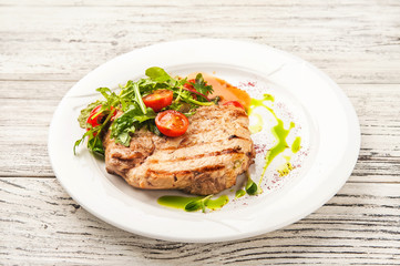 Chicken fillet in a restaurant close-up. Wild duck fillet with vegetables on a white plate and copy space.