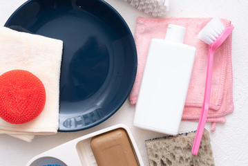Dish washing accessories on white flat lay background. Washing up concept.