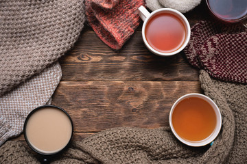 Various hot drink such as herbal tea, green tea, black tea,milk tea and warm clothes on wooden...