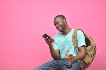 handsome excited young black man feeling excited while viewing content on his smartphone